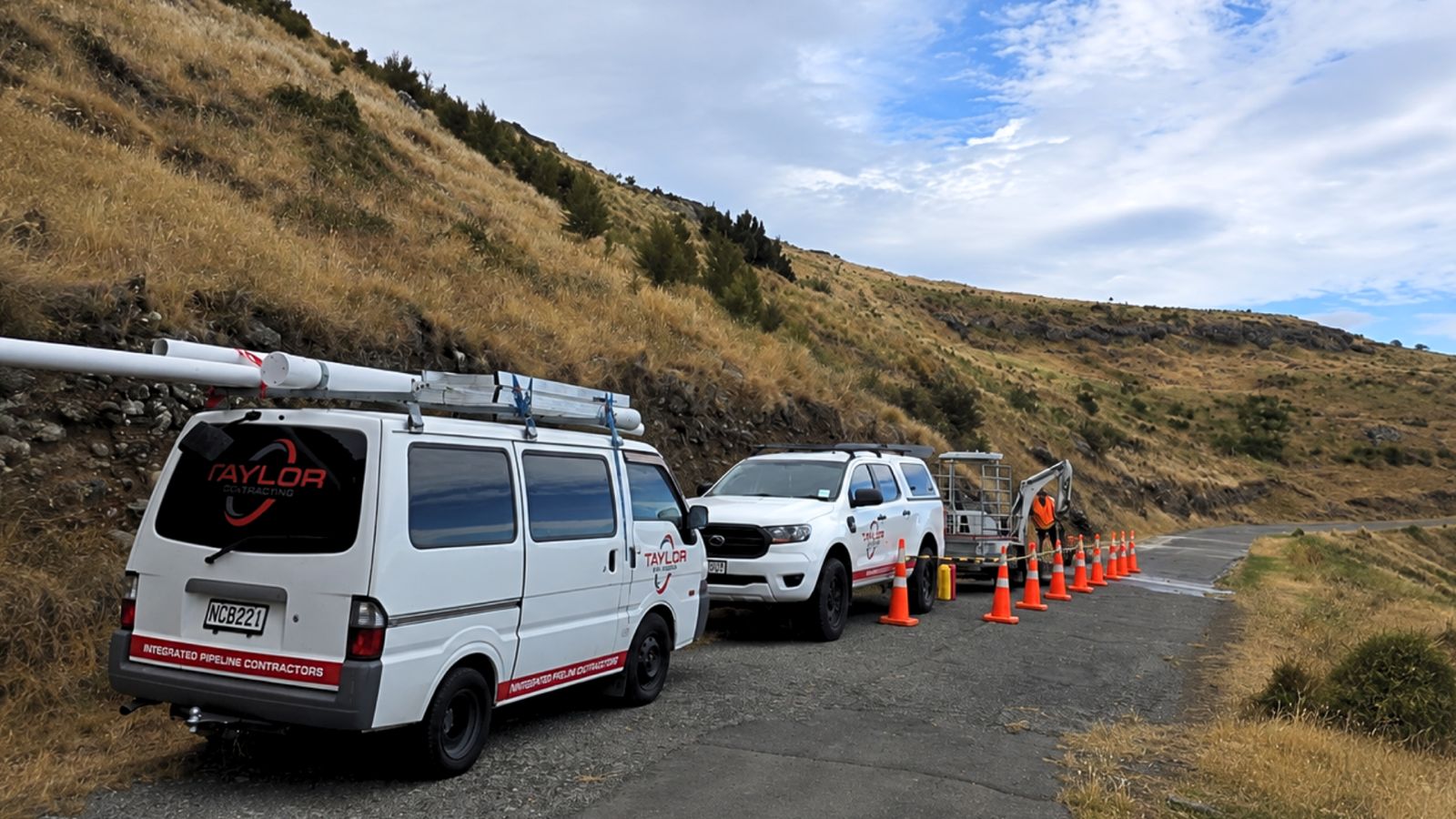 Taylor Plumbing van, ute and mini excavator on an Auckland job site